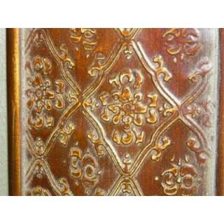   mirror features an embossed design on a copper over wood the copper
