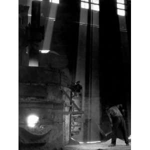 Worker Shoveling Limestone Into an Electric Blast Furnace at Republic 
